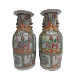 A PAIR OF CHINESE CANTON EXPORT FAMILLE-ROSE VASES 19th century, painted in enamels with panels of