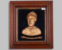 A head and shoulders gilt-metal portrait of the Victorian jockey Fred Archer