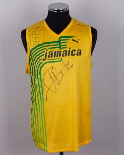 Usain Bolt a yellow and green Jamaica autographed vest