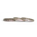THREE RINGS comprising of;- a 'fresh' scroll engraved platinum wedding ring, size L, a white metal