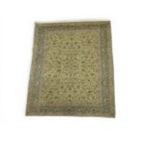 A LIGHT GREEN GROUND FINE PILE KASHAN RUG with all over multicoloured floral/foliate design within