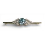 A BLUE ZIRCON & DIAMOND BROOCH the mount in white metal with safety clasp, length 5cm, diameter of
