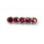 A RUBY ETERNITY RING with a yellow and white 18ct gold mount, set with five rubies each approx 3.