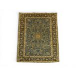 A BLUE GROUND FINE PILE KASHAN RUG with dark blue sunburst central medallion on extensively