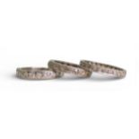 THREE DIAMOND ETERNITY RINGS A platinum half eternity ring, set with estimated approx 0.60cts of