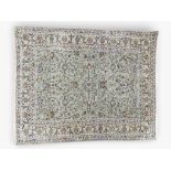 A LIGHT BLUE GROUND FINE PILE KASHAN RUG  with extensive floral/foliate decorated ground within