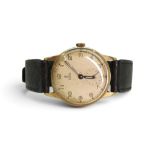 A 9CT GOLD TUDOR WATCH with cream patinaed dial silvered Arabic numerals with blued steel hands.