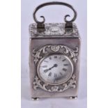 AN ANTIQUE WILLIAM COMYNS SILVER CARRIAGE CLOCK. 380 grams overall. 10 cm high inc handle.