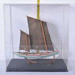 A cased model of a 19th Century fishing boat 31 x 29 x 16.5 cm
