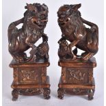 A FINE PAIR OF 18TH/19TH CENTURY CHINESE CARVED WOOD BUDDHIST LIONS possibly huanghuali.