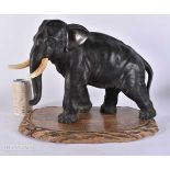A 19TH CENTURY JAPANESE MEIJI PERIOD BRONZE ELEPHANT OKIMONO modelled upon a wooden base. Elephant