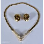 A Boxed Christian Dior Gold Tone V Shaped Pendant embellished with clear crystals and a