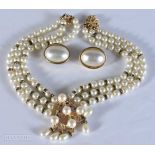 A Christian Dior Three Strand Faux Pearl Necklace to gether with Christian Dior Clip-on Earrings.
