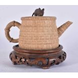 A CHINESE YIXING POTTERY TEAPOT AND COVER upon an associated stand. 15 cm wide.