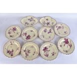 AN UNUSUAL SET OF EARLY 19TH CENTURY CREAMWARE BOTANICAL PLATES painted in puce with flowers.