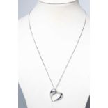 A GEORG JENSEN SILVER YEAR OF THE HEART PENDANT designed by Karim Rashid for Georg Jensen, on a