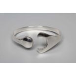 A GEORG JENSEN SILVER PUZZLE BANGLE designed by Hans Hansen, stamped 925, Danmark (Illustrated)