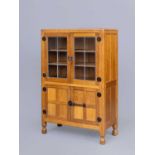 A ROBERT THOMPSON ADZED OAK DISPLAY CABINET, the half penny moulded cornice over two leaded glass