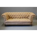 A VICTORIAN WALNUT FRAMED CHESTERFIELD SOFA, second half 19th century, button upholstered in a