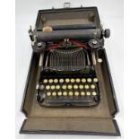 A Portable Corona QWERTY Typewriter, black, all keys appear to work correctly, folds into a black ca