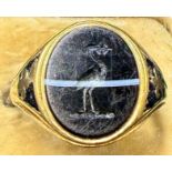 An 18 carat gold and enamel mourning ring set with banded agate with stork crest to top. Inscription