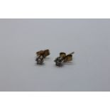 A PAIR OF 9CT GOLD DIAMOND STUD EARRINGS.