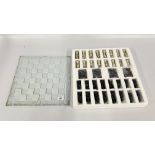 A FANTASY DRAGON CHESS SET WITH GLASS BOARD.