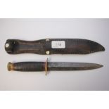 TAYLOR WITNESS WW2 FIGHTING KNIFE WITH LEATHER SHEAF.