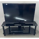SONY BRAVIA 40" TV ON TWO TIER BLACK GLASS TV STAND - SOLD AS SEEN.
