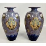 A PAIR OF ROYAL DOULTON STONEWARE VASES DECORATED WITH TUBE LINED ROUNDELS, ONE A/F.