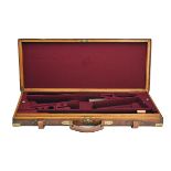 A BRASS-CORNERED OAK AND LEATHER DOUBLE GUNCASE, fitted for 26in. barrels (could adjust to 31in.),