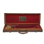 HENRY ATKIN (FROM PURDEY'S) A BRASS-CORNERED OAK AND LEATHER SINGLE GUNCASE, fitted for 28in.