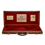 HOLLAND & HOLLAND A BRASS-CORNERED OAK AND LEATHER DOUBLE GUNCASE, fitted for 30in. barrels, the