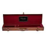 A TAN LEATHER SINGLE GUNCASE, fitted for 30in. barrels, the interior lined with maroon baize, a