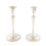 A PAIR OF GEORGE III SILVER CANDLESTICKS