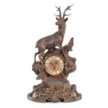 A 19TH CENTURY BLACK FOREST CARVED LINDEN WOOD MANTLE CLOCK