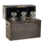 A 19TH CENTURY BRASS BOUND COROMANDEL AND CUT GLASS THREE-BOTTLE DECANTER BOX
