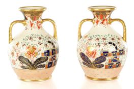 A PAIR OF 19TH CENTURY COPELAND SPODE IMARI PATTERN CERAMIC ENGLISH BOTTLE VASES