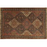 AN ANTIQUE TRIBAL QASHQAI RUG