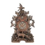 A 19TH CENTURY BLACK FOREST CARVED LINDEN WOOD CUCKOO MANTEL CLOCK