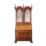 A GEORGE I BURR WALNUT BUREAU BOOKCASE WITH BROKEN ARCH PEDIMENT AND MIRRORED DOORS