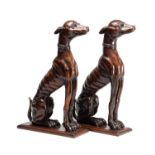 A FINE PAIR OF 18TH CENTURY CARVED WALNUT HERALDIC GREYHOUND FIGURES