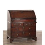 A WILLIAM AND MARY OAK BUREAU ON BRACKET FEET