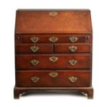 AN EARLY 18TH CENTURY OAK BUREAU WITH THREE SHORT DRAWERS