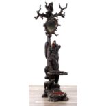 A 19TH CENTURY BLACK FOREST CARVED LINDEN WOOD BEAR HALL STAND WITH HEART-SHAPED MIRROR