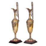 A PAIR OF LATE 19TH CENTURY BRONZE EWERS ON SLATE AND ROUGE MARBLE BASES