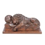A 19TH CENTURY SWISS CARVED LINDEN WOOD SCULPTURE OF THE LION OF LUCERNE