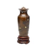 A MEIJI PERIOD JAPANESE MIXED METAL VASE ON CARVED WOOD STAND