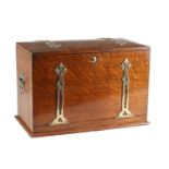 AN ARTS AND CRAFTS OAK WRITING BOX WITH PIERCED BRASS MOUNTS