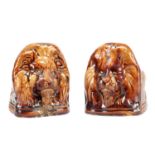 A PAIR OF 19TH CENTURY STAFFORDSHIRE TREACLE GLAZED EARTHENWARE LION'S HEAD SASH WINDOW SUPPORTS
